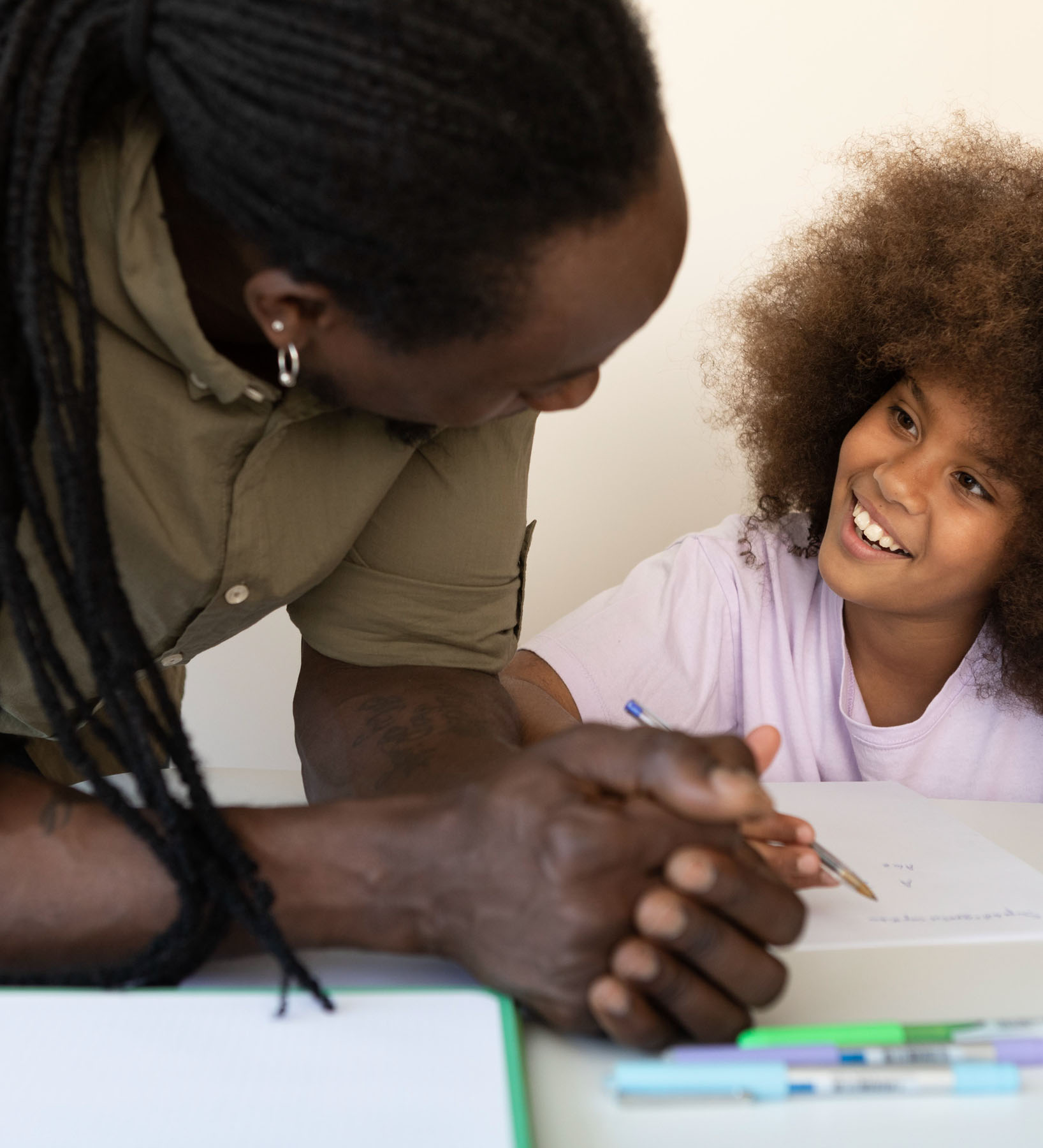Self determined African American boy dressed in sports clothes planking at gym, feeling tired. Indoor image of black male kid doing elbow plank on floor at gym. Endurance and strength concept